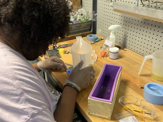 Student preparing soap for All Natural Goats Milk Soap